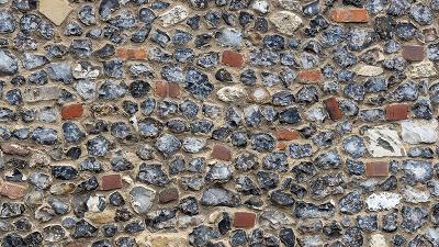 construction worker applying mortar to build a wall using bricks number 18 in the masonry process